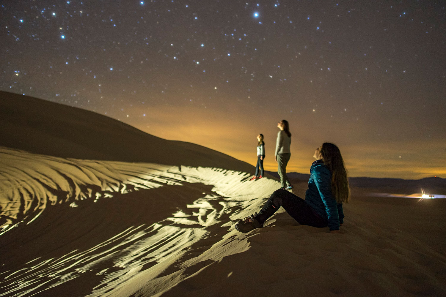 Three women gazing at the stars in wonder.