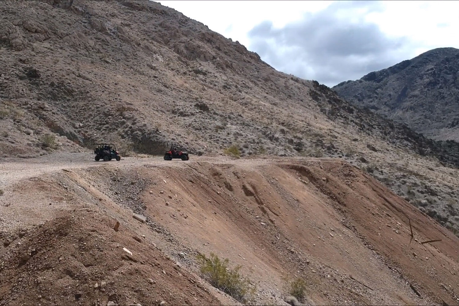 Two ATVs parked on mining tailings