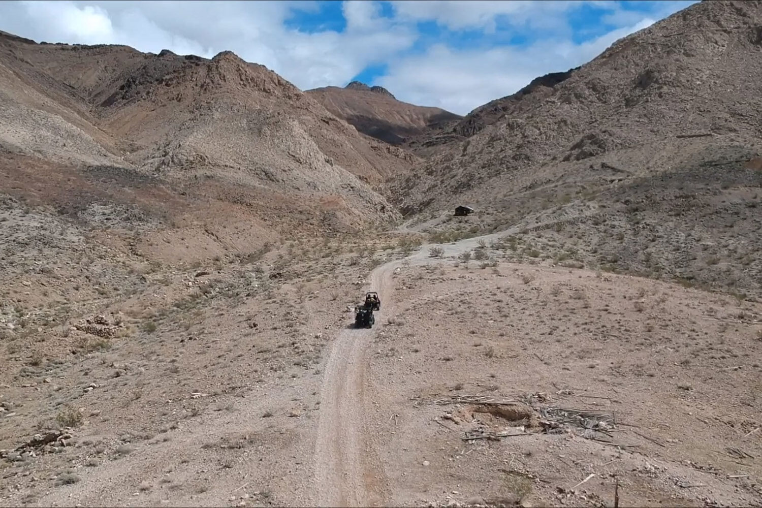 Two ATVs guided through a desert wilderness