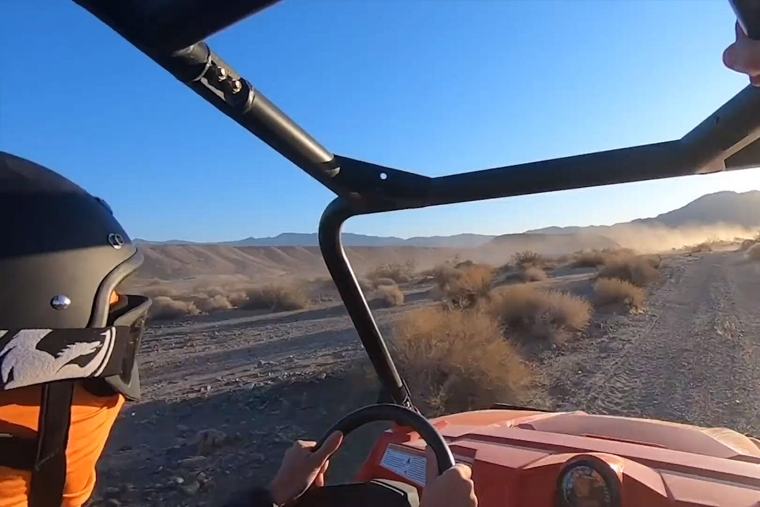 Driver in ATV on a desert trail
