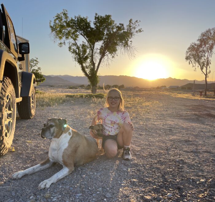 Marlina hugging dogs at sunset near Death Valley National Park