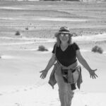 Cynthia walking through the Mojave Desert near the Amargosa Basin, the landscape she calls home.